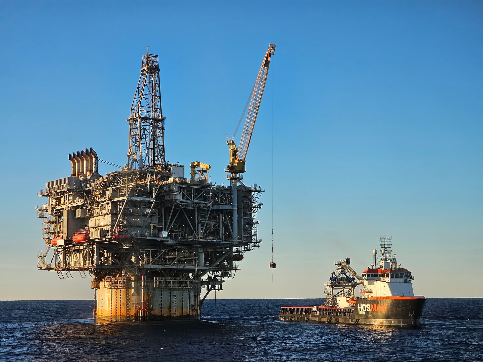 Offshore production platform with a supply vessel alongside
